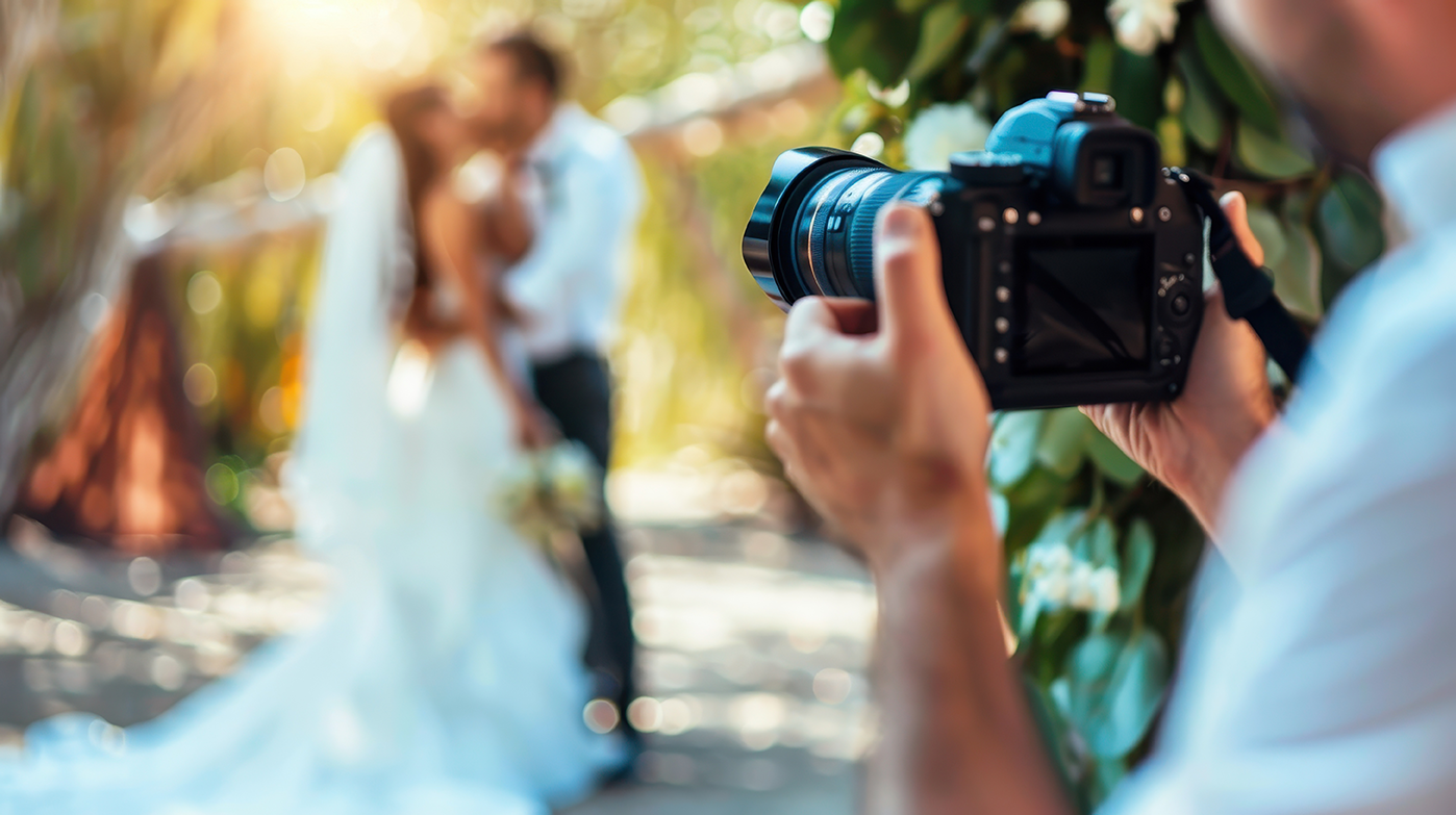 Professional Wedding Photographer taking picture of bride and groom for wedding album